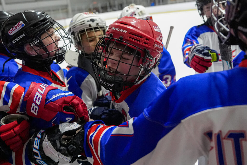 A group of athletes playing football with helmet on the field