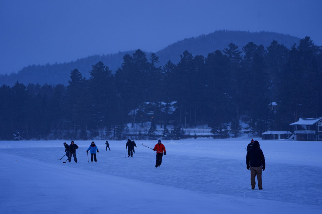A group of athletes skating with helmet on the rink
