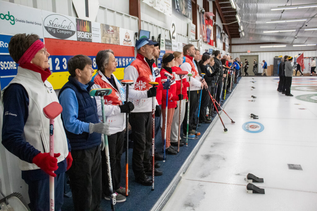 A group of athletes competing curling