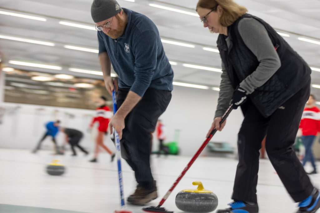 A group of athletes competing curling