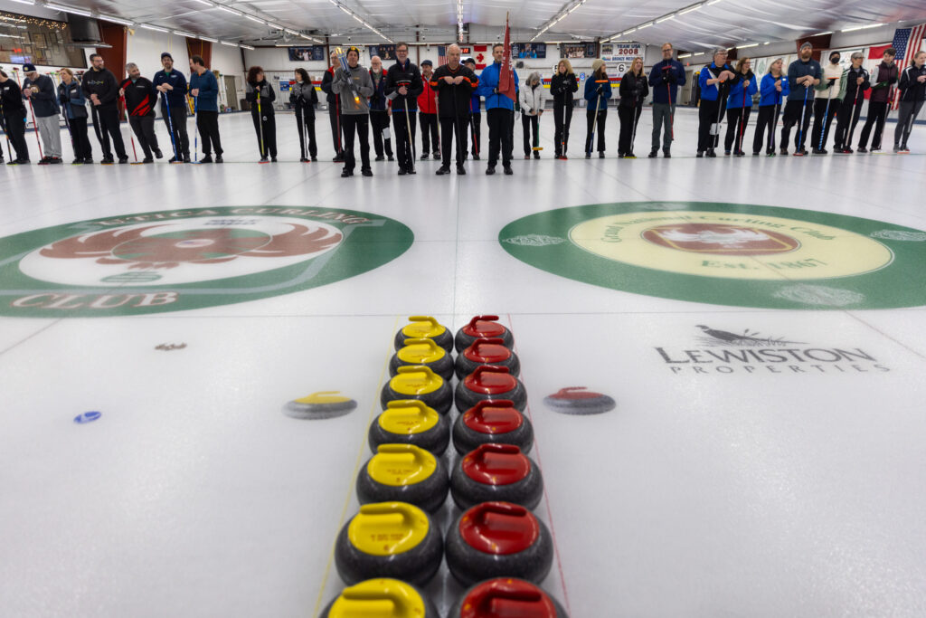 A group of athletes competing curling