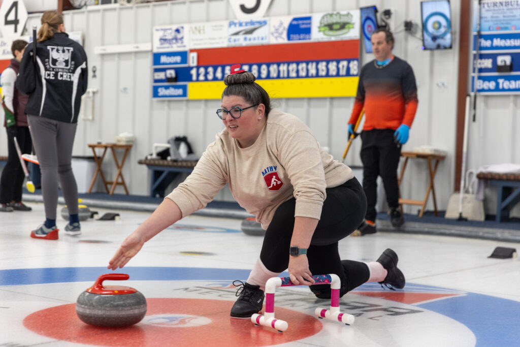 A group of athletes competing curling