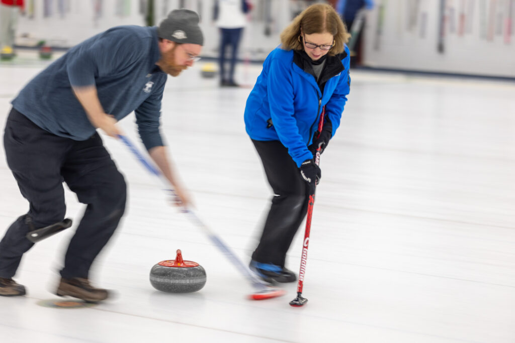 A group of athletes competing curling