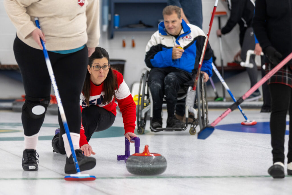 A group of athletes competing curling