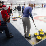 A group of athletes competing curling