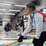 A group of athletes competing curling