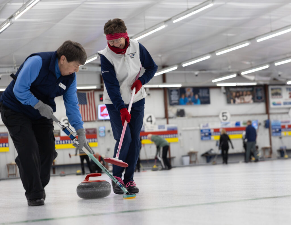 A group of athletes competing curling