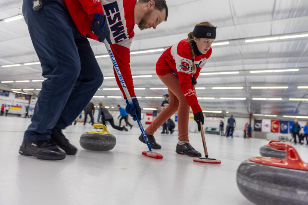A group of athletes competing curling