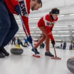 A group of athletes competing curling