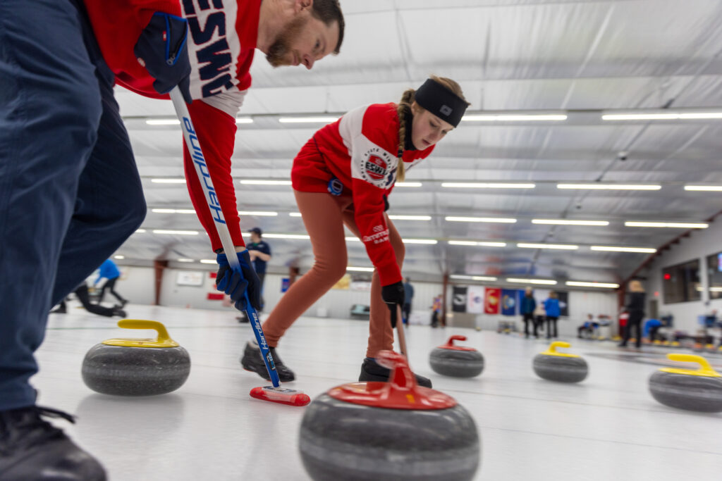 A group of athletes competing curling