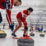 A group of athletes competing curling
