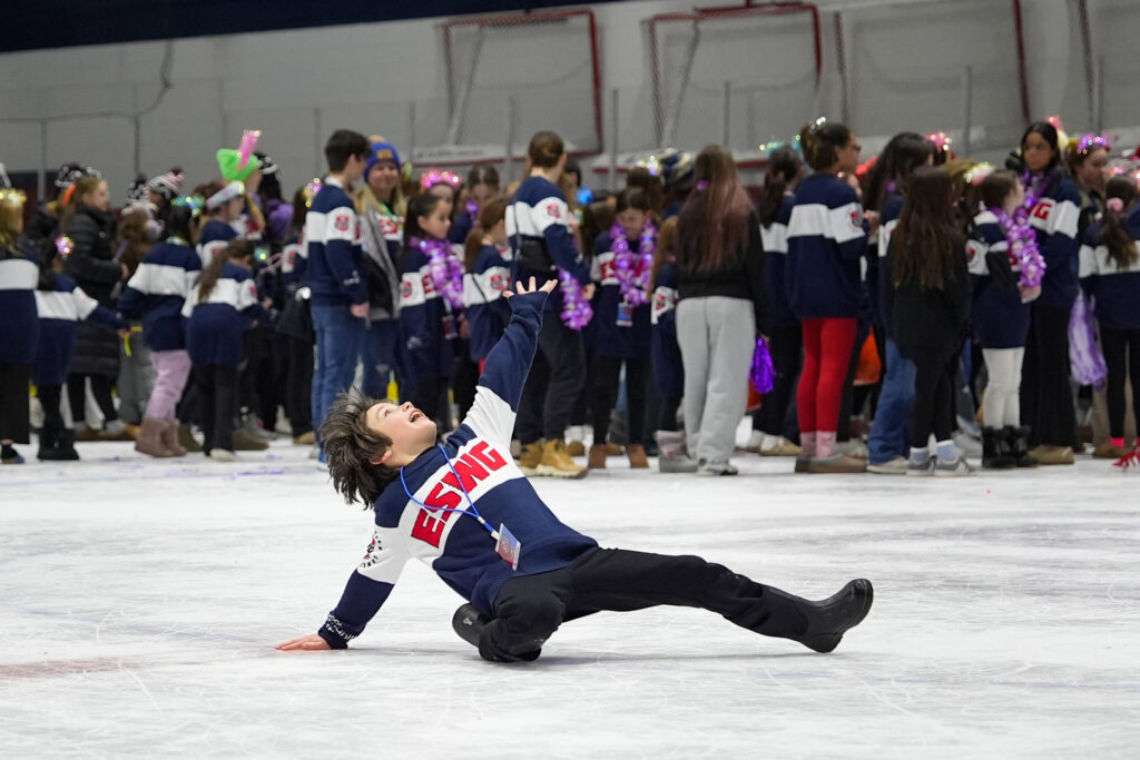 A group of athletes skating with helmet on the rink