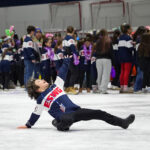 A group of athletes skating with helmet on the rink