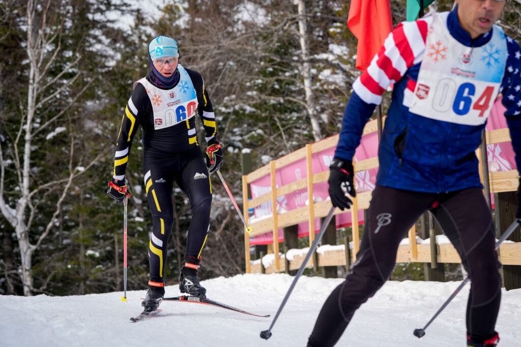 Two athletes skiing in the snow