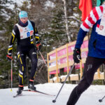 Two athletes skiing in the snow