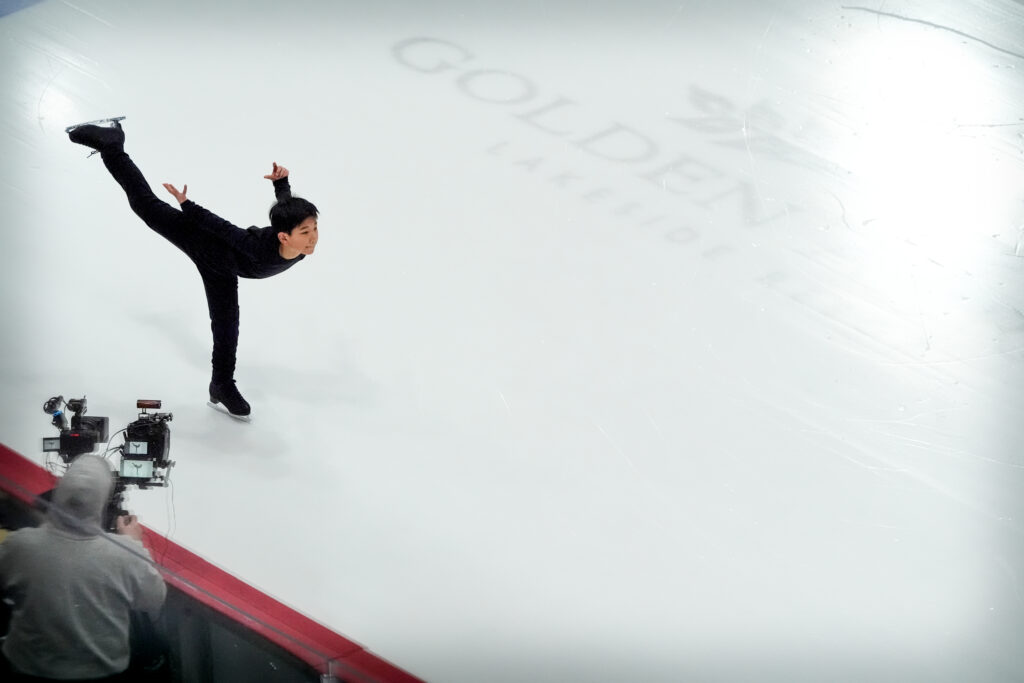 Two athletes skating on the rink