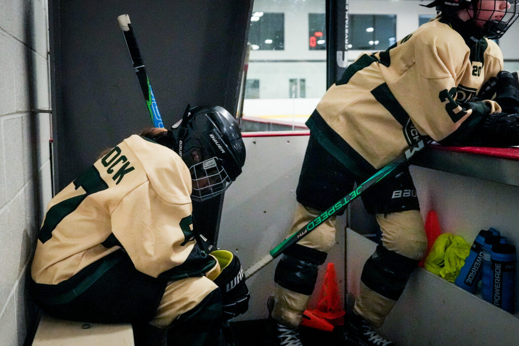 Two athletes competing in athletic event sports with helmet