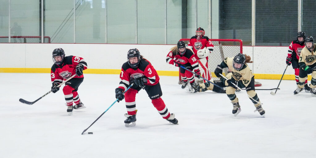 A group of athletes skating with helmet on the rink