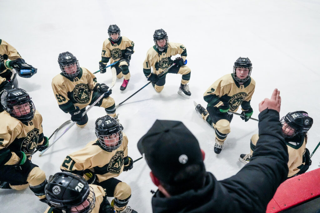 A group of athletes skating with helmet on the rink