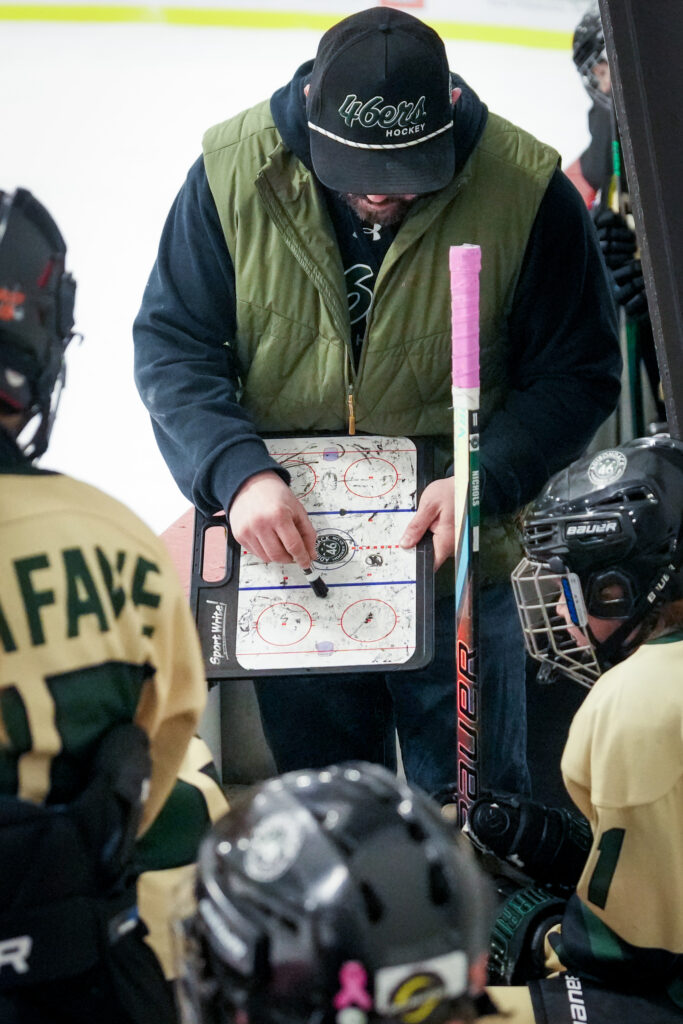 A group of athletes playing football with helmet on the field
