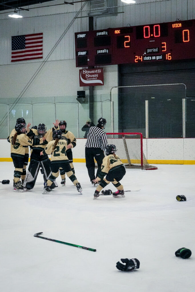 A group of athletes skating with helmet on the rink