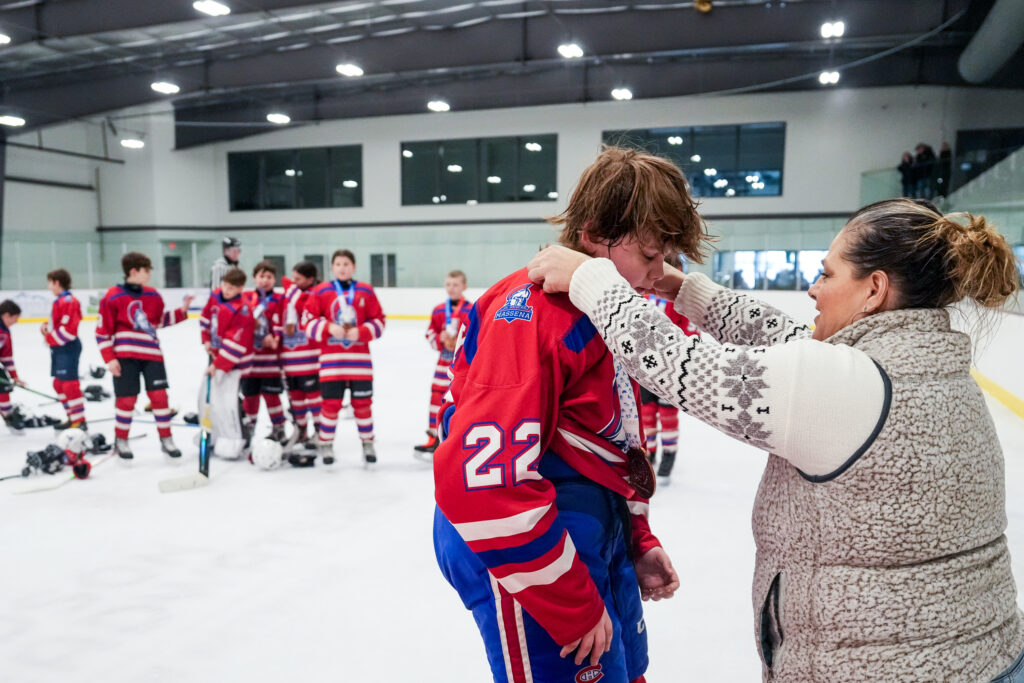 A group of athletes playing soccer with ball on the field