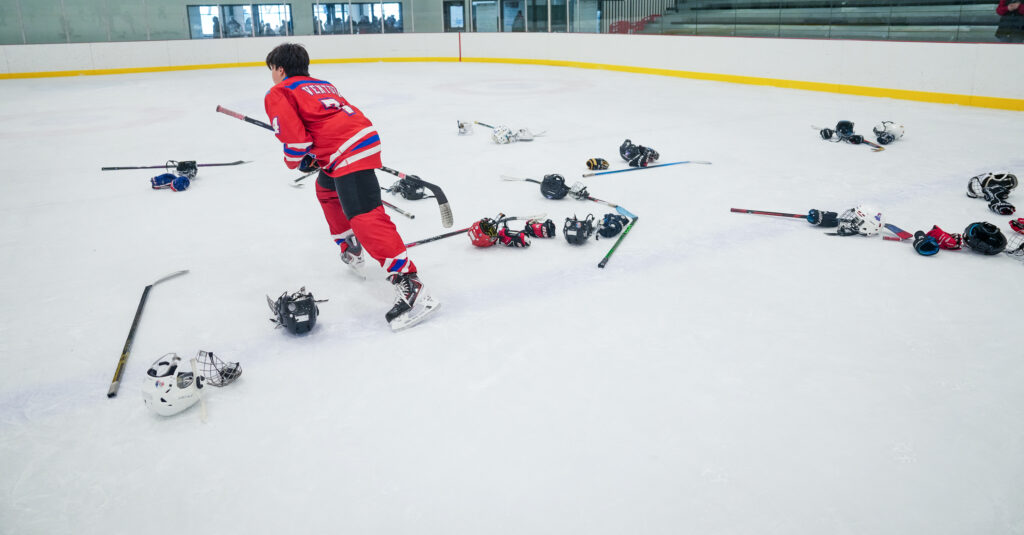 A group of athletes skating with helmet on the rink