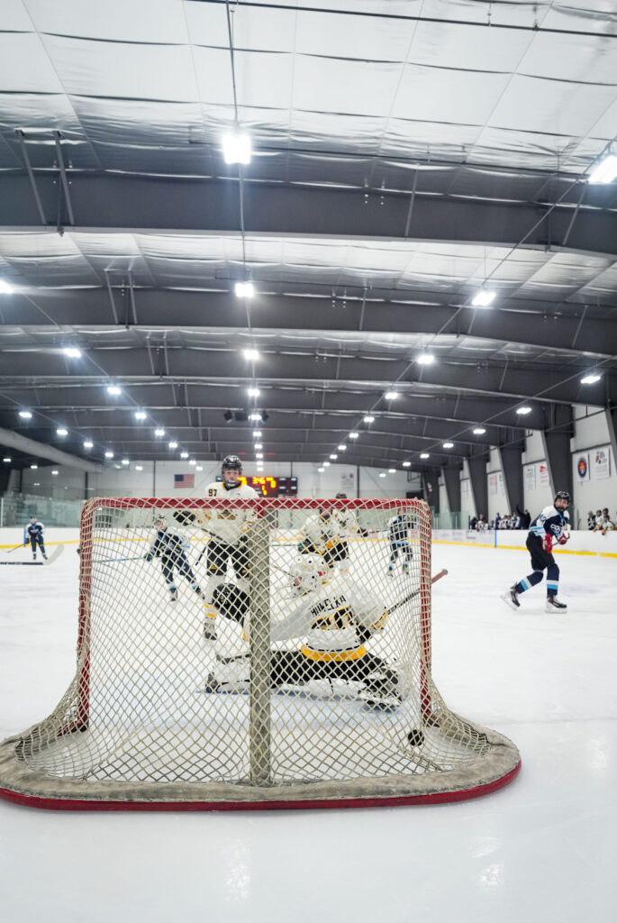 A group of athletes skating with helmet on the rink