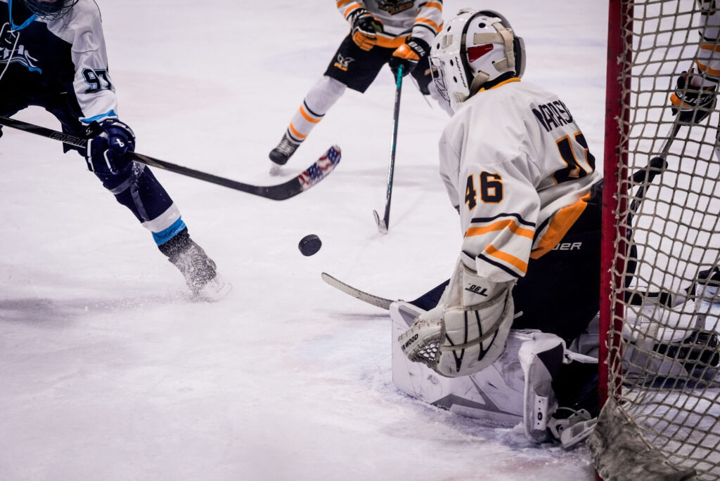 A group of athletes skating with helmet on the rink