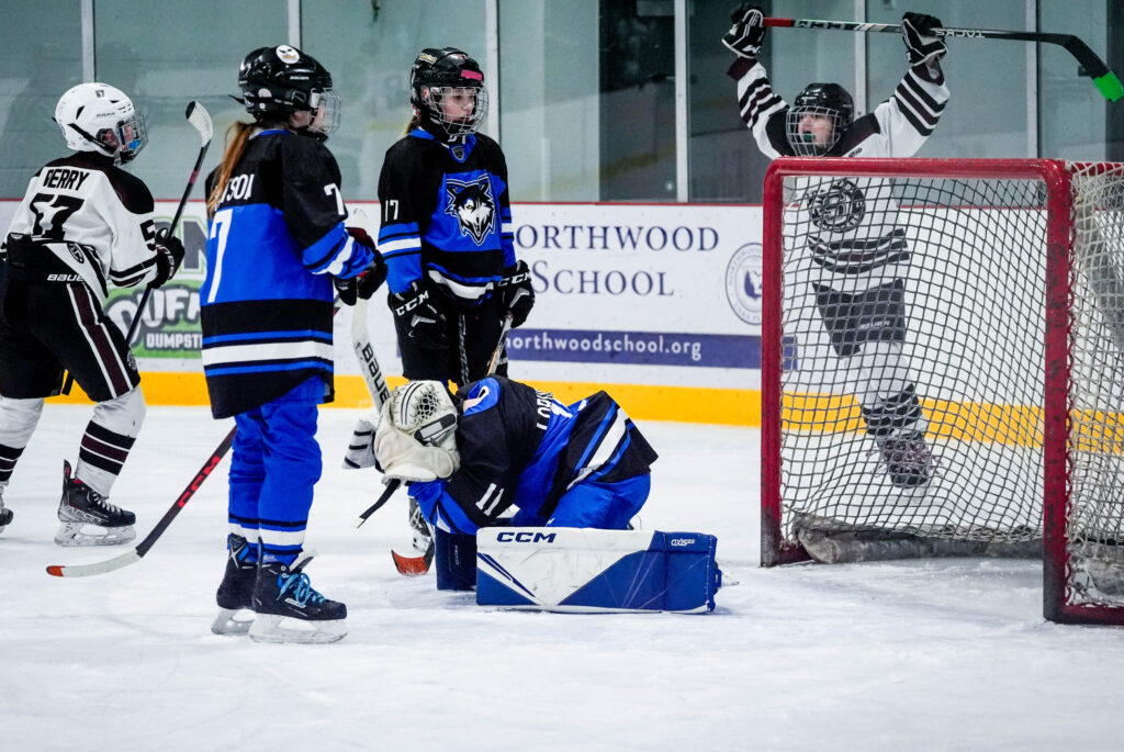 A group of athletes skating with helmet on the rink