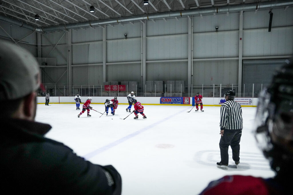 A group of athletes skating with helmet on the rink