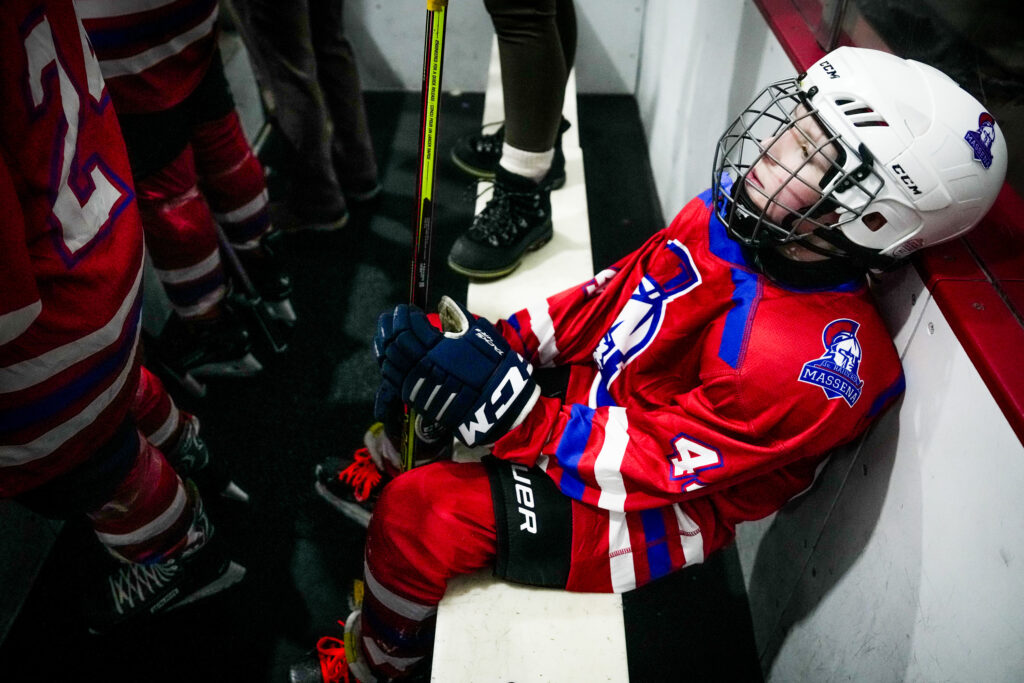 A group of athletes skating with helmet on the rink