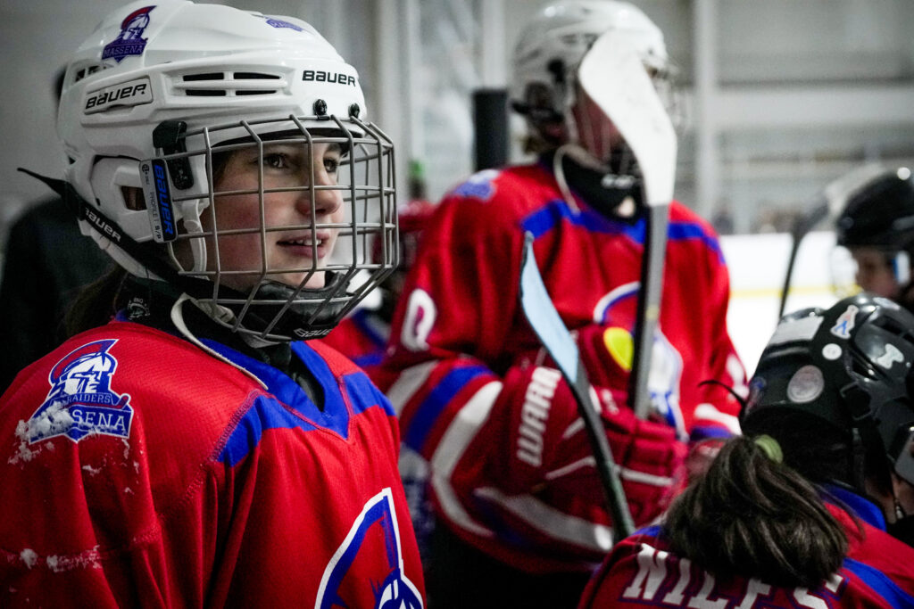 A group of athletes playing football with helmet on the field