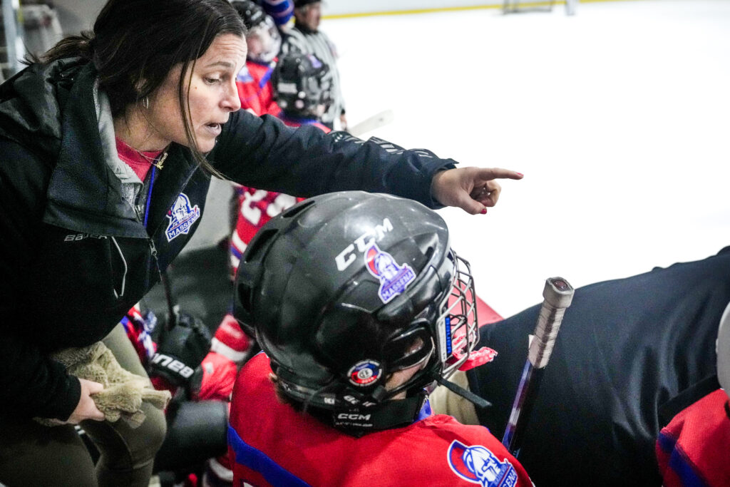 Two athletes playing football with helmet on the field