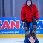 Two athletes skating on the rink