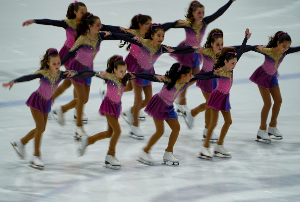 A group of athletes skating on the rink