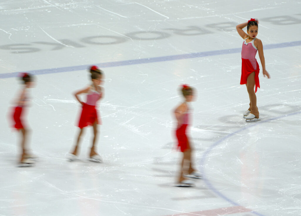 A group of athletes skating on the rink