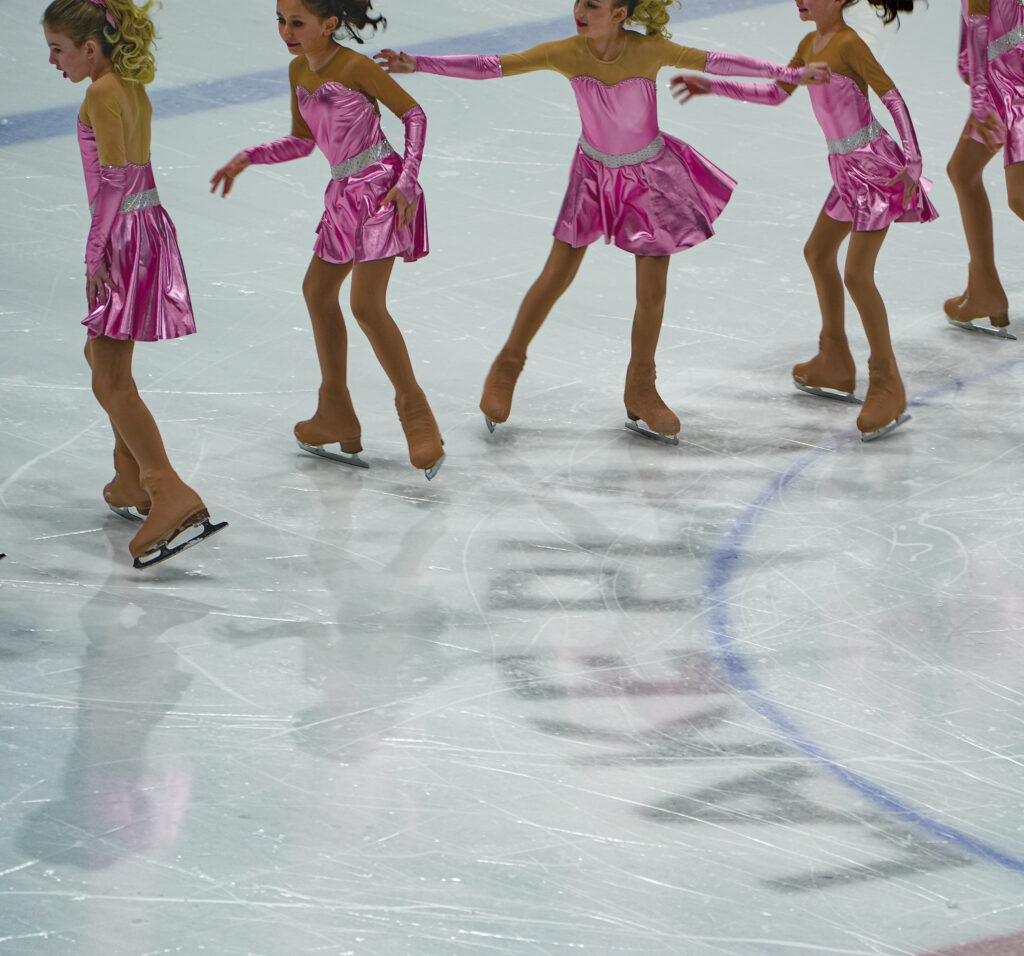 A group of athletes skating on the rink