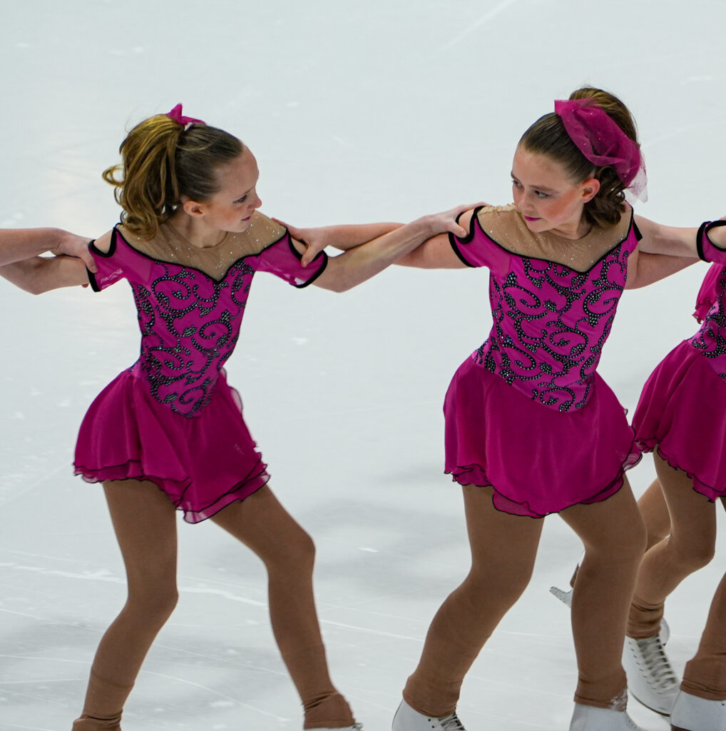 A group of athletes skating on the rink