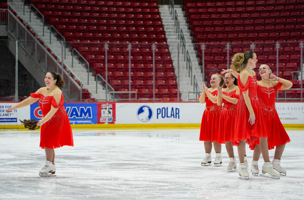 A group of athletes skating on the rink