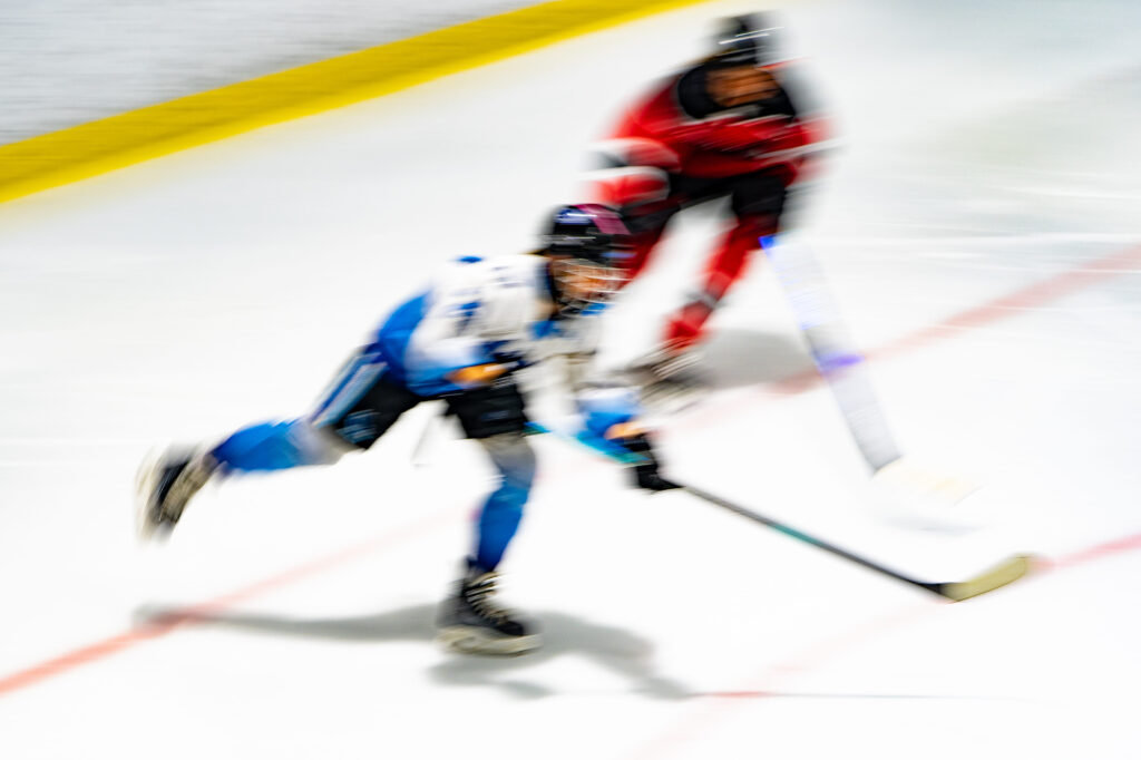 Two athletes competing in athletic event sports with helmet