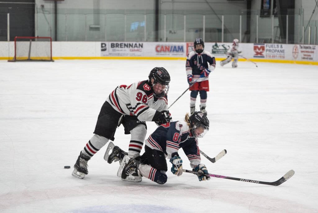 A group of athletes skating with helmet on the rink