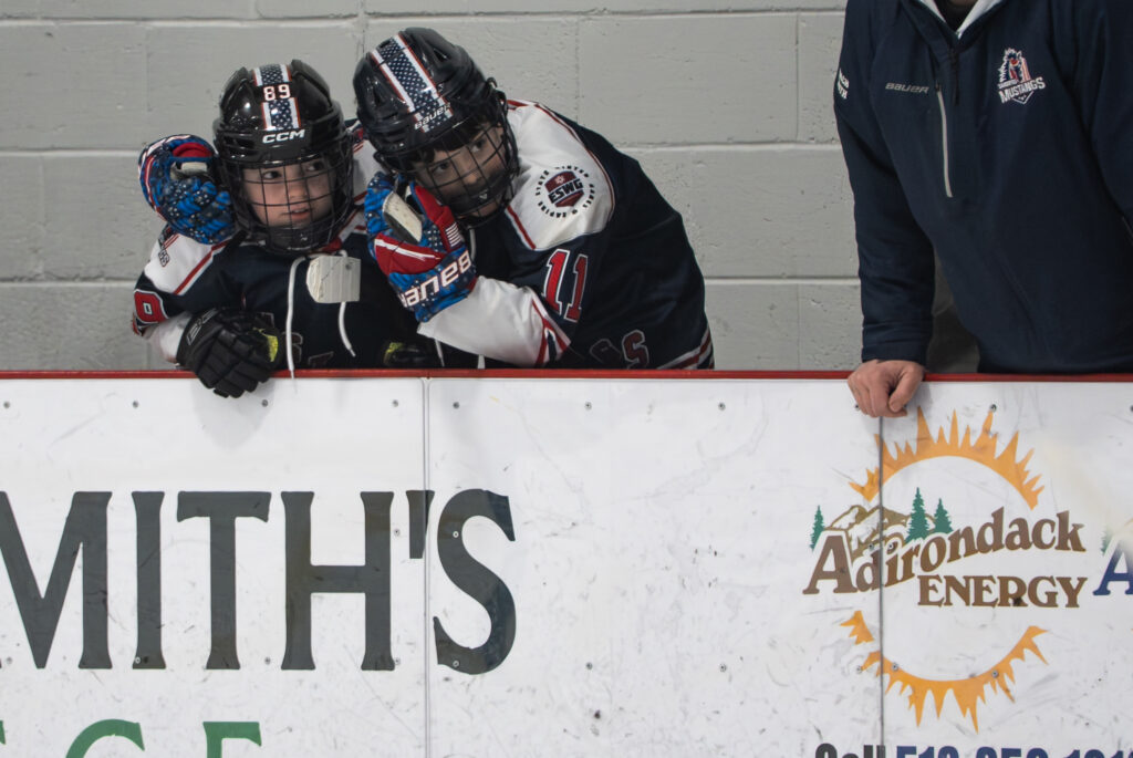 A group of athletes playing baseball with helmet on the field
