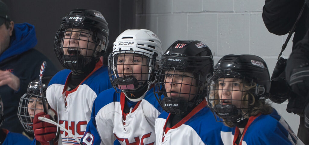 A group of athletes playing football with helmet on the field
