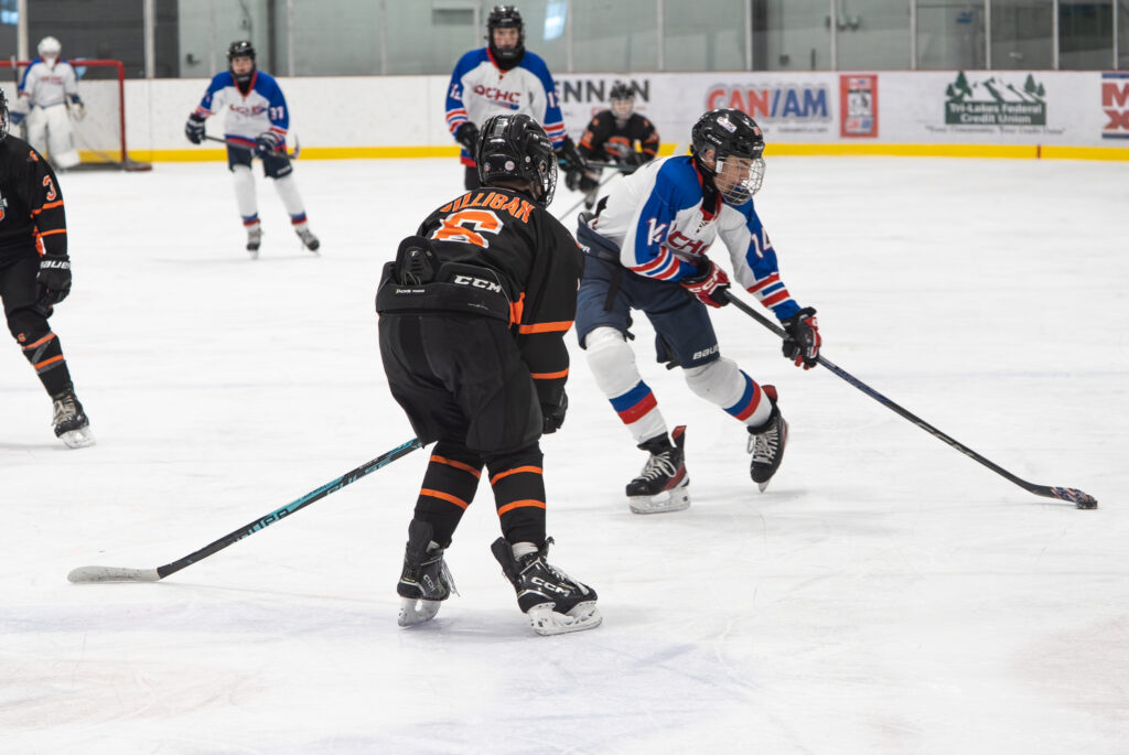 A group of athletes skating with helmet on the rink