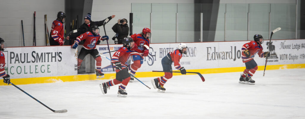 A group of athletes skating with helmet on the rink