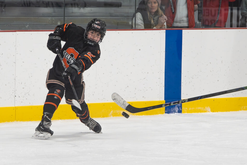 A group of athletes skating with helmet on the rink