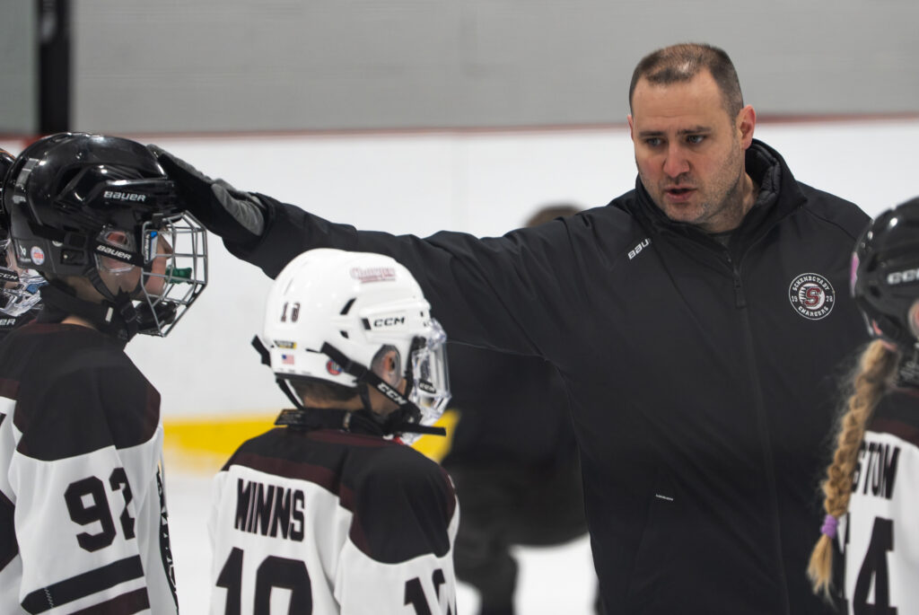 A group of athletes playing football with helmet on the field