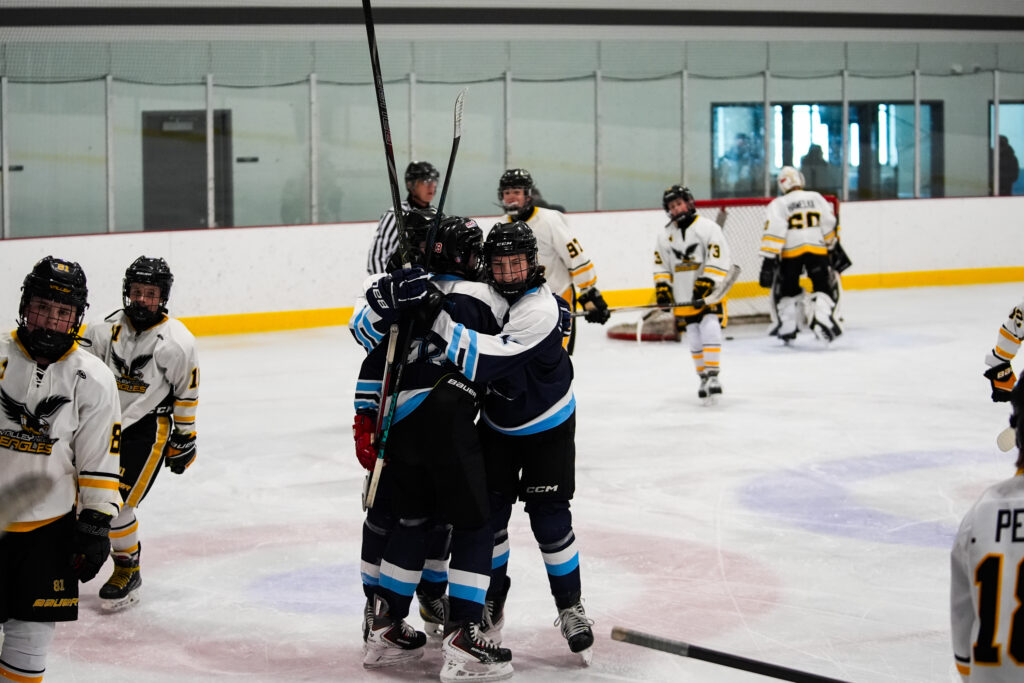 A group of athletes skating with helmet on the rink