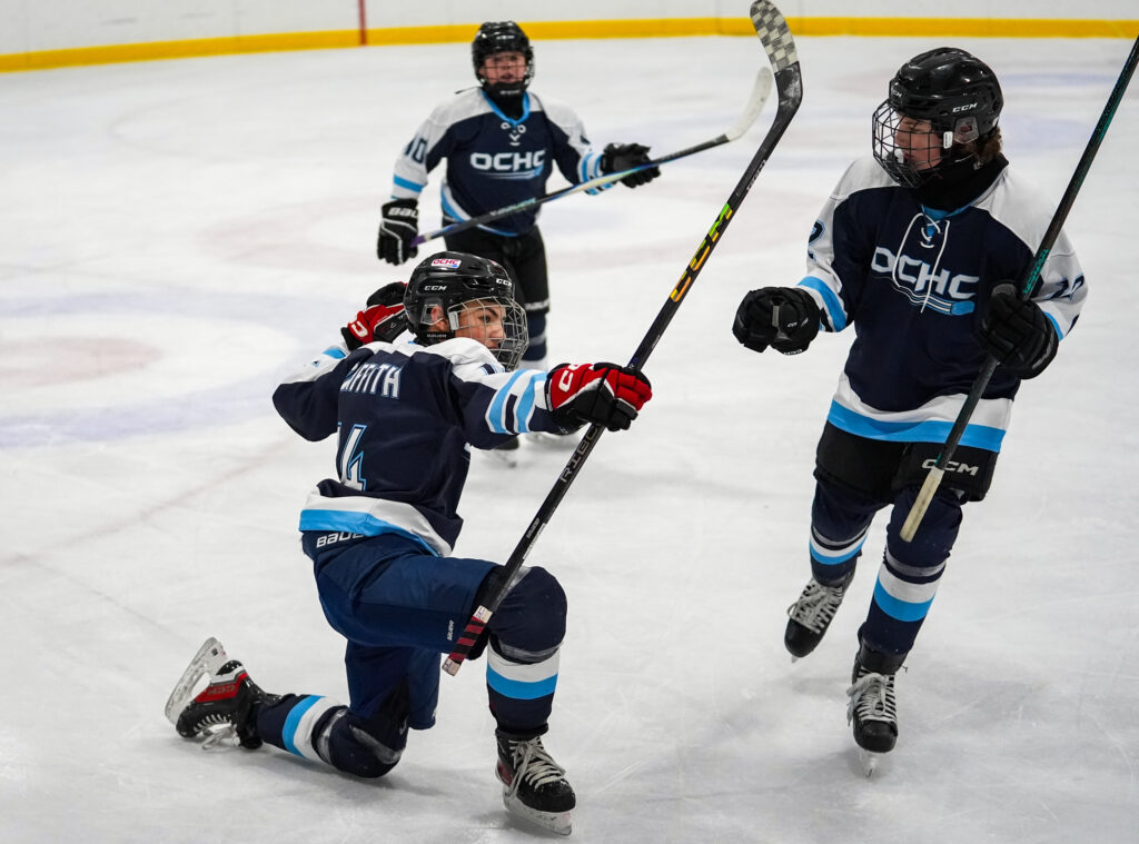 A group of athletes competing ice hockey with helmet